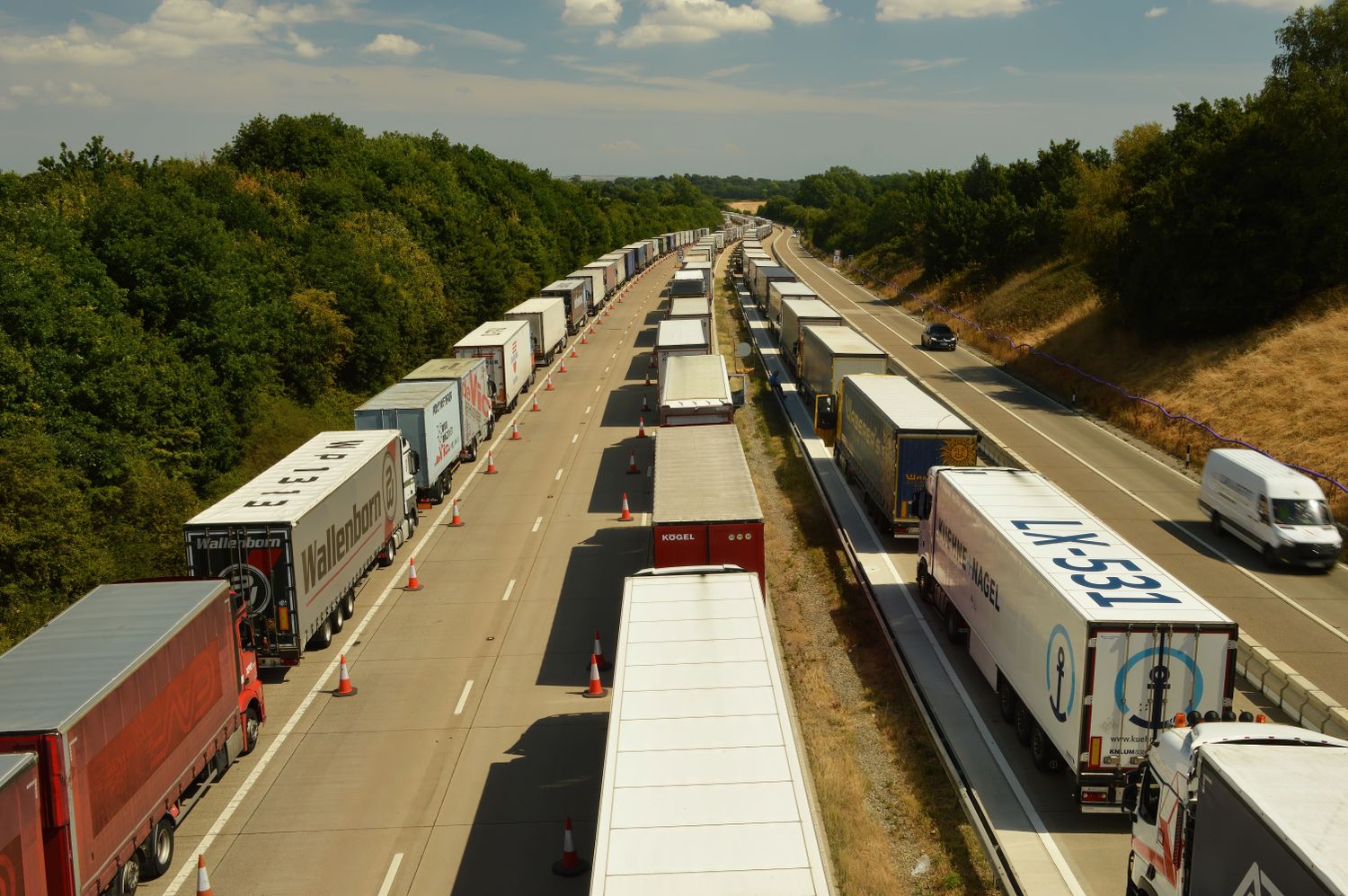 Freight trucks on a tree-lined highway